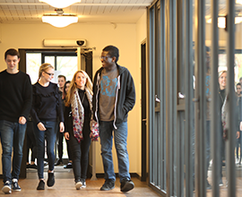 A group of students walking through the Hope corridors